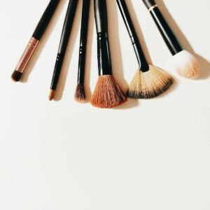 A set of makeup brushes arranged on a white surface, perfect for beauty and cosmetic themes.
